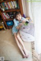 A woman sitting on the floor with a stuffed animal.