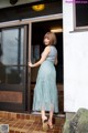 A woman standing in front of a glass door.